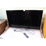 A 40 inch Samsung flatscreen television with remote control, model UE40D8000