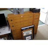 A two-piece modernist yew wood finished set of drawers, one slender five drawer, the other double