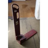 A painted wooden boot jack