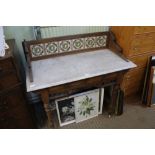 A 19TH CENTURY MARBLE TOPPED WASHSTAND, with decorative tile back, having two inline drawers,