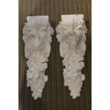 A pair of decorative cast plaster corbels depicting bird of prey