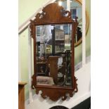 AN EARLY 19TH CENTURY MAHOGANY FRET FRAME WALL MIRROR, 54cm in length