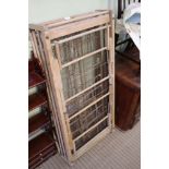 A LATE 19TH/EARLY 20TH CENTURY FOLDING SOFTWOOD TRAVEL COT