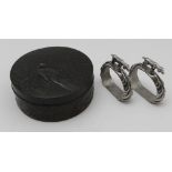 A pair of silver plated napkin rings of stirrup form, mounted with gun dogs, together with a far