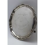 Emile Viner, a silver salver of Georgian piecrust form, raised on three scroll feet, Sheffield 1937,