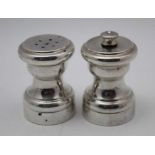 A pair of 'sterling' silver capstan design condiments, comprising a salt & pepper grinder (2)
