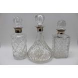A collection of three silver collar, cut glass decanters, with stoppers, one square form spirit