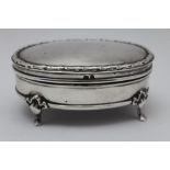 Henry Clifford Davis, An Edwardian oval silver jewellery box, hinged lid, raised on four cabriole