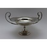 An early 20th century silver bon-bon dish, having scroll handles on knop stem, and circular foot,