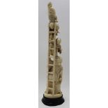 A Japanese Meiji period carved figure group, Buddha type figure supports a ladder on which