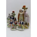 A 19th century Staffordshire pottery taper holder, figures at the well, 31cm high, together with