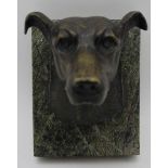 A 19th century cast bronze mask of a terrier dog, mounted on a polished marble block (possibly