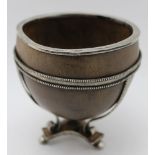 An early 19th century Colonial white metal, mounted coconut shell bowl, the triform base bears