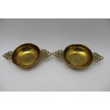 A pair of 18th century British brass porringers, each having two cast handles bearing crown motif,