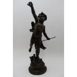 A late 20th century bronzed metal figure, 'Cupid' bow in hand, a quiver at his foot, on circular