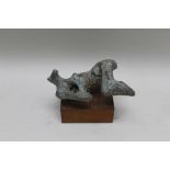A patinated abstract bronze form, 28cm long mounted on a wooden block base, 23cm high inclusive