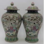 A pair of 20th century Chinese ceramic covered vases of baluster form, hand painted in the famille