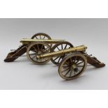 A pair of model brass field gun cannons, complete with loading push rods & cleaning rods