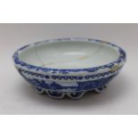 A Qing dynasty Chinese porcelain brush wash pot, raised on lug feet, blue decoration with