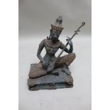 A verdigris patinated cast metal figure of the Taiwanese musician, having gilt painted highlights