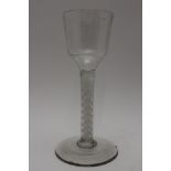 A George III cordial glass, raised on cotton twist stem and conical foot with unground pontil, 14.