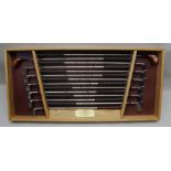 A limited edition oak cased wall hanging set of Macgregor golf clubs being reproductions, played
