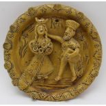 A mid-20th century British Studio pottery roundel, moulded and applied King & Queen design, ochre