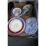 A box containing a series of collectors plates