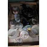 A box of domestic and collectable pottery to include coloured Pratt ware pot lids