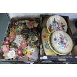 Two boxes containing a wide selection of floral pottery platters and plaques