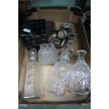 A box containing decanters and stoppers domestic metal wares to include hallmarked silver frames