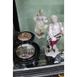 A pair of continental porcelain figurines, together with two wooden framed transfer decorated pot