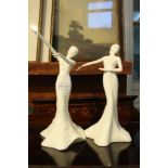 A pair of white glazed Coalport porcelain dancing female figurines