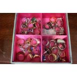 A small jewellery box containing a large selection of rings various