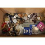 A box containing a selection of collectors world coinage, wristwatches, etc.