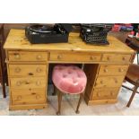 A modern pine twin pedestal desk, having three inline drawers over two pedestals each with three