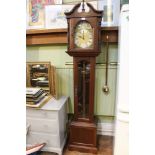 A modern mahogany finished long case clock display pendulum weights standing approximately 6 feet
