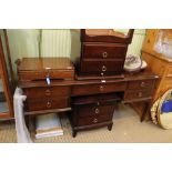 A mahogany finished stag branded dressing table and pair of bedside units