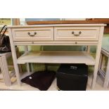 A lime wash effect side unit having rectangular top over two in-line drawers and pull-out