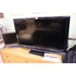 A remote-controlled Sony bravia flatscreen television, together with a small Sony monitor each