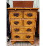 A small proportioned oak chest, having pull-out slide over two pairs of in-line drawers and two