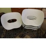 A set of four stacking Ron Arad, Tom Vac chairs produced by vitra with off-white cast shell on