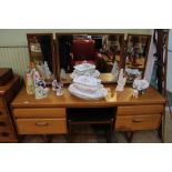 A William Lawrence of Nottingham Teak finished dressing table with triple plain plate mirrored