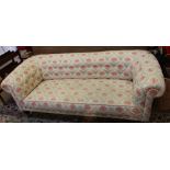 A 2.5 person size Chesterfield sofa, all over upholstered in flower head and trellis printed