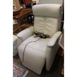 An Italian made ivory leather upholstered electronic reclining armchair