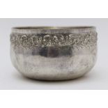 A Far Eastern (possibly Balinese) white metal bowl, planished body with embossed border band, 12.5cm