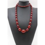 A cherry amber bakelite graduated bead necklace, 88cm long, weight 78g