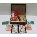 A wooden box containing a good selection of spinners & lures