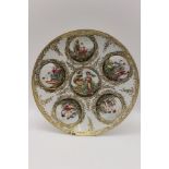 An Italian porcelain wall plaque, capo di monte type, moulded with roundels of figurers, hand