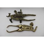 Two South Asian betel nut cutters, one with contemplative head and hands in prayer, together with